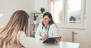 Female doctor seeing a patient in her medical room