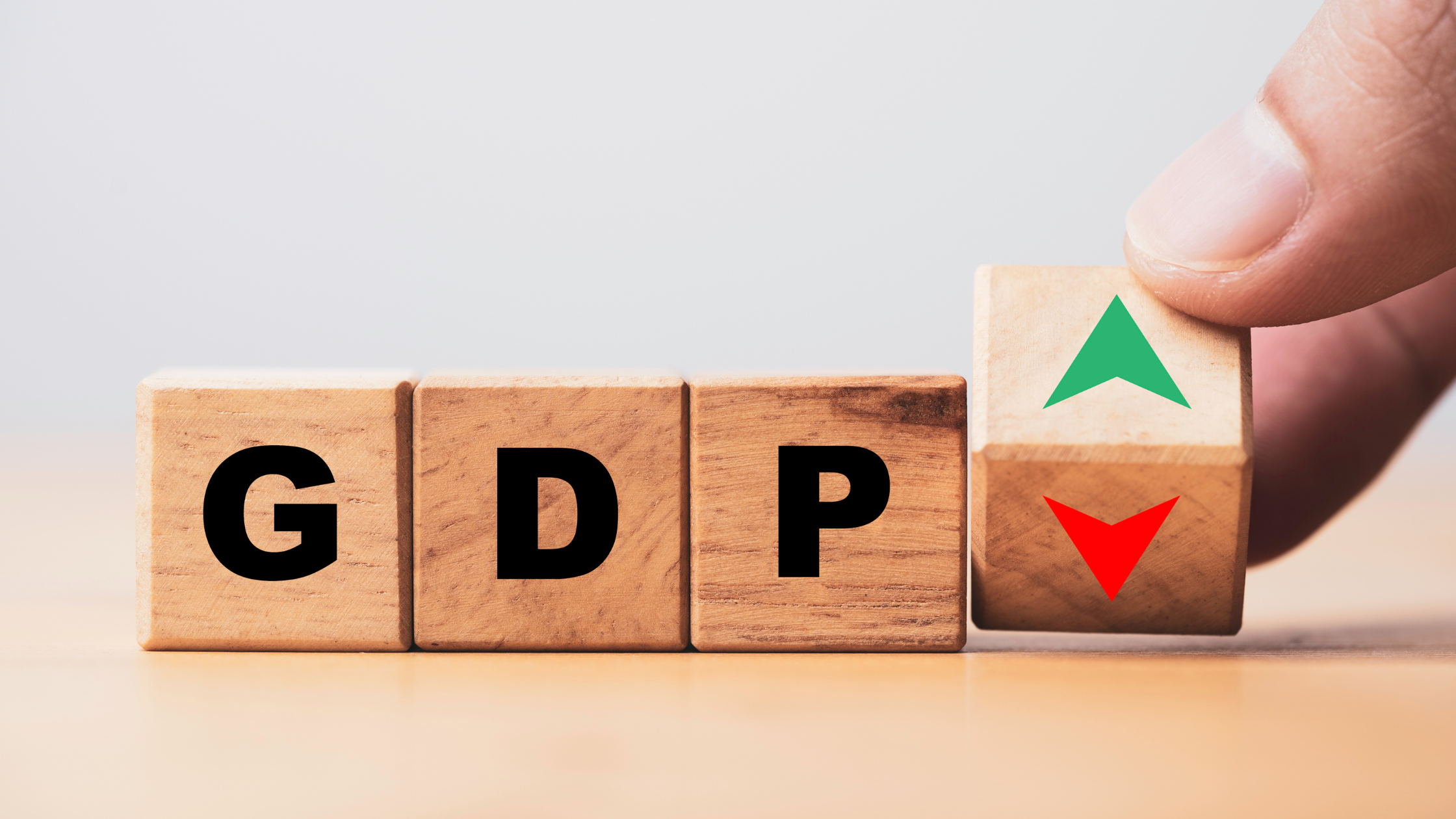 photo of three wooden blocks with the letters GDP