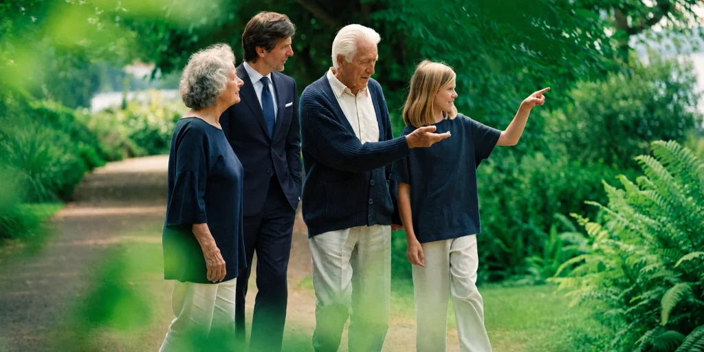 Illustration of a family walking through a leafy park with a wealth adviser in a navy suit.